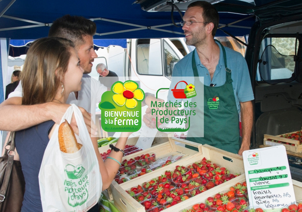 Un couple discute avec un producteur de fraise sur le Marché des producteurs de Pays